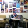 Student studying on campus with art in background