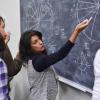 Teacher writing on a blackboard in the classroom