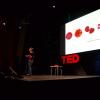 Stock photo of a woman speaking at a TEDx event
