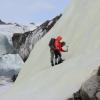 researchers working on a glacier surface in the High Arctic