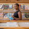Stephanie Toliver in a comic book store reading an issue of "Ironheart"