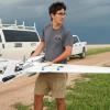 Smead Scholar Alex Hirst, a graduate researcher, helps get a drone ready for launch.