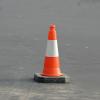 Orange traffic cone on pavement