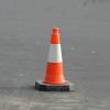Orange traffic cone on pavement