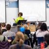 A person speaks at a lectern. 