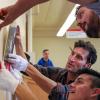People install part of an exhibit celebrating 50 years of UMAS
