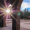 Sun peaks through columns on campus
