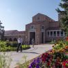 Students walking past UMC, flower beds in full bloom