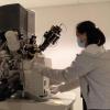 Tomoko Borsa, facility manager for the COSINC Characterization Facility, uses an instrument as the facility slowly resumes research activities.