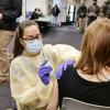 Nurse administering a vaccine on campus