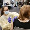 Healthcare worker administers a COVID-19 vaccine during a campus clinic