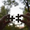 Person holding two puzzle pieces