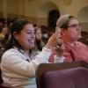 Audience member takes a photo during a Conference on World Affairs session