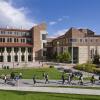 Campus community members walking by the Visual Arts Complex on campus