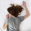 A stock photo of a woman sleeping on a bed
