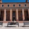 student sitting on a bench at Norlin Quad