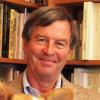 Warren Motte in front of a bookcase
