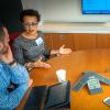 Colleagues attend a webinar in a conference room