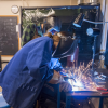 female mechanical engineering student welding
