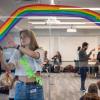 Student helps set up a room for a student workshop