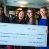 Business minor business plan competition winners pose with giant check