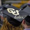  Woman with a graduation cap that reads "CU later"