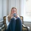 A woman relaxing with a mug of drink