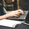 Women types on laptop