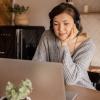 A woman watching video on a laptop