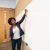 A woman writing on a dry erase board