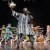 Black man leading an African dance performance