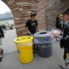 Students help fans sort their recyclables and compostables at a CU football game.