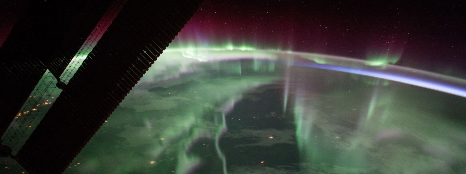 View of Earth from space glowing during an aurora