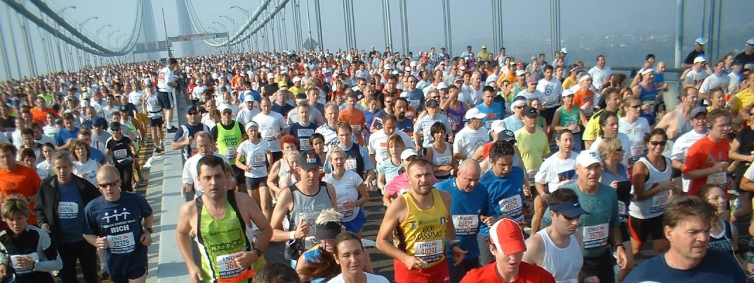 Thousands of people run across a bridge