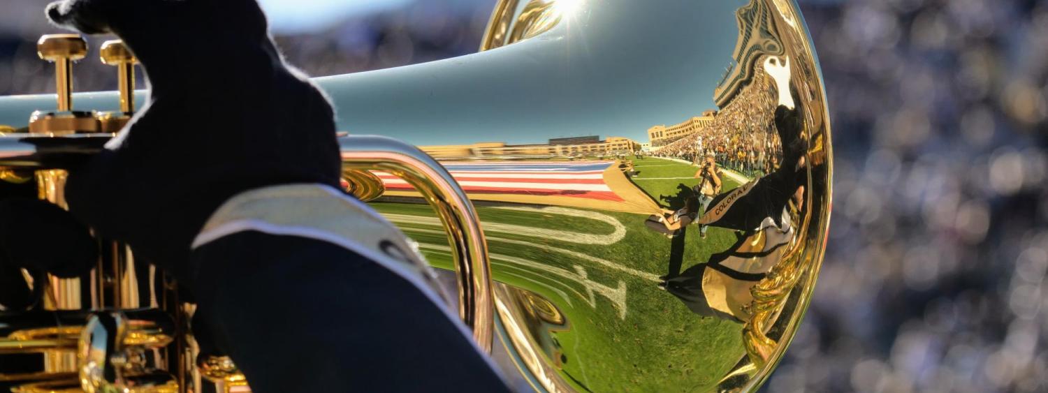 Gold Buff Marching Band member plays marching euphonium during Homecoming game