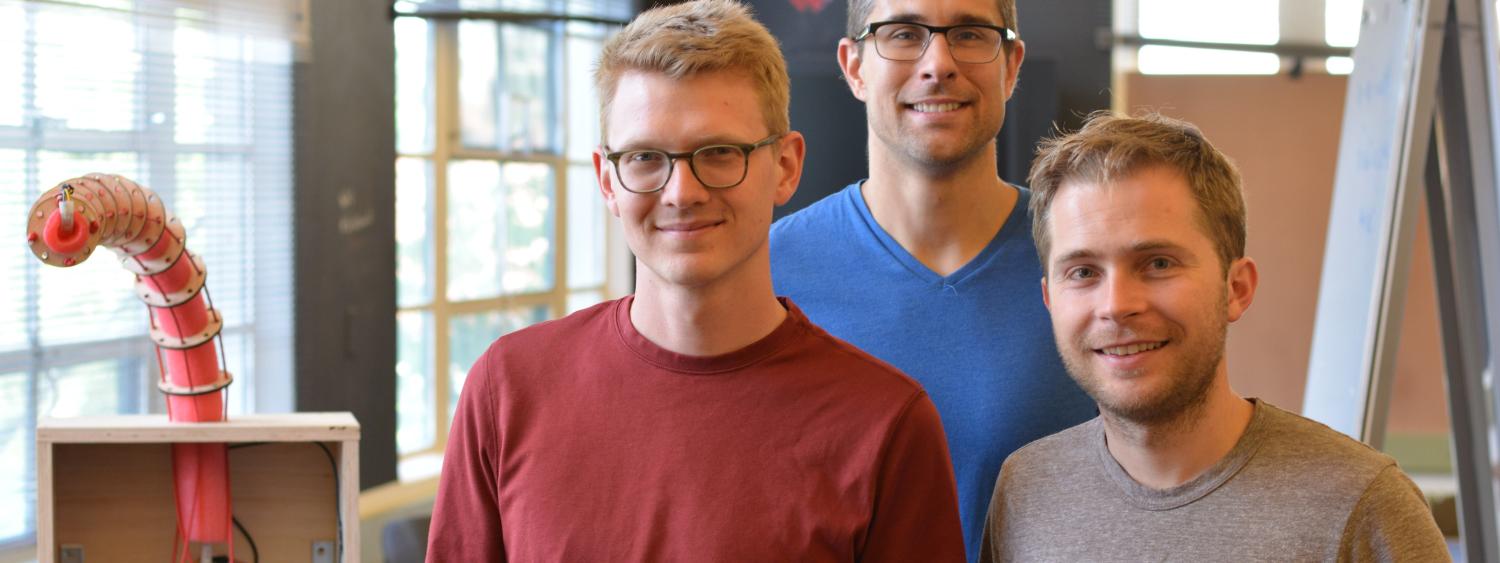 Three students pose with SMART Tentacle project