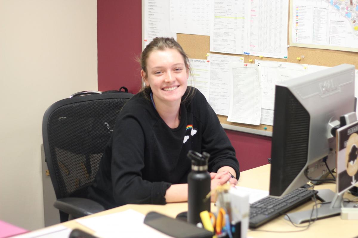 A student at her desk in the CU Events Planning & Catering office