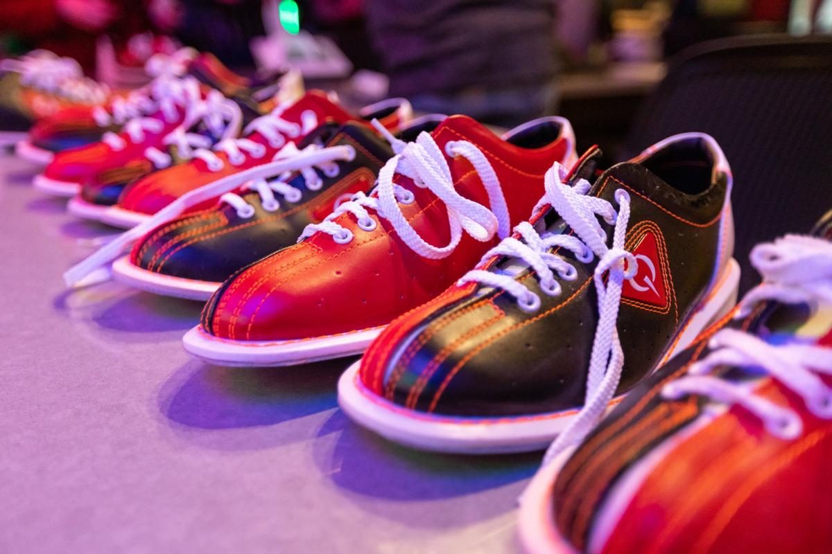 A row of red and black bowling shoes