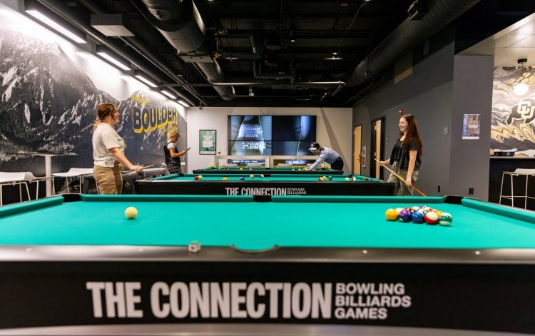 picture of students playing billiards at The Connection