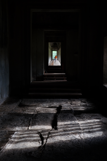 A photo of a dark room with a small window in the back
