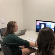 Student reviewing design on a desktop computer