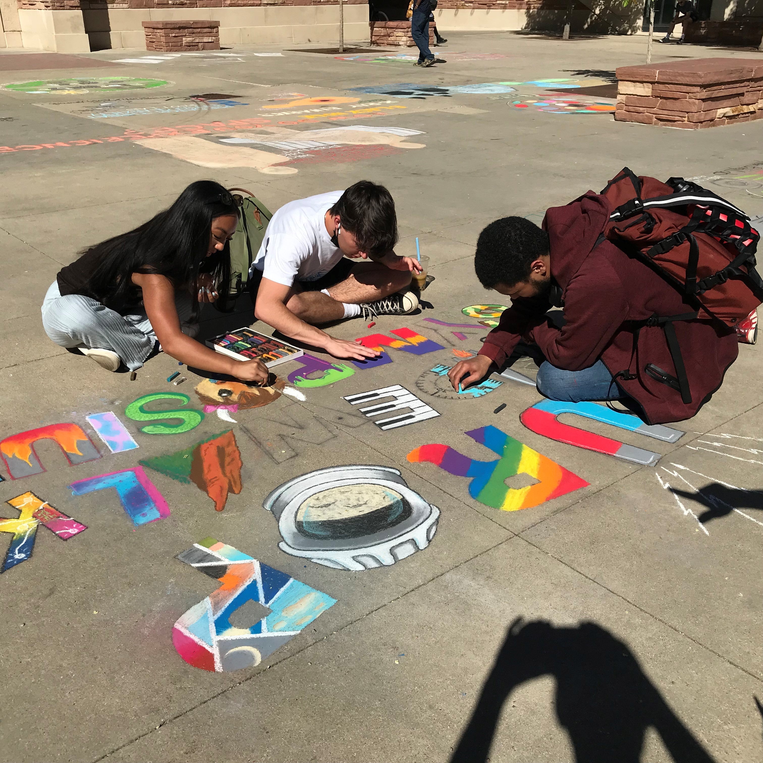 Student creating chalk art