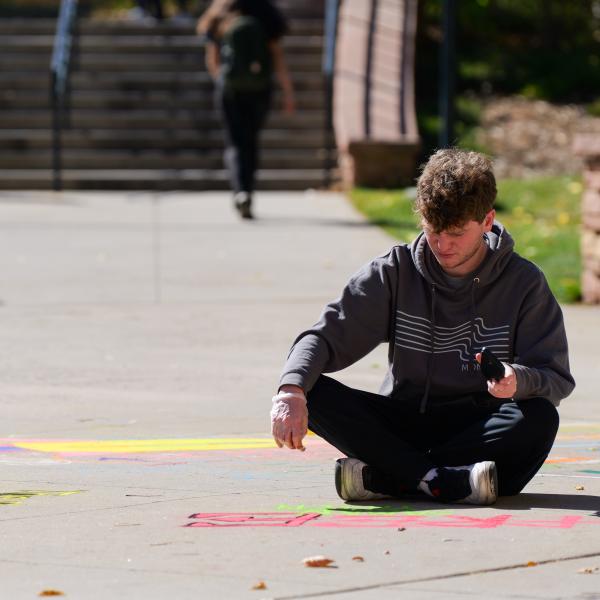 Student creating chalk art