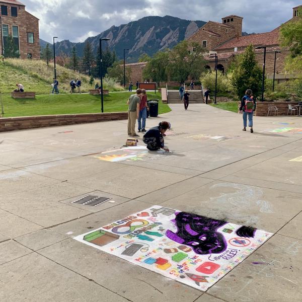 Student creating chalk art