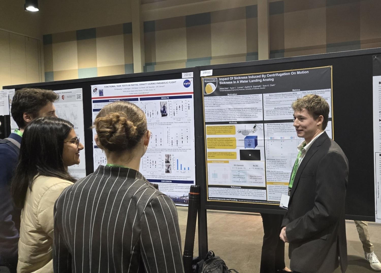 Student presenting their research poster