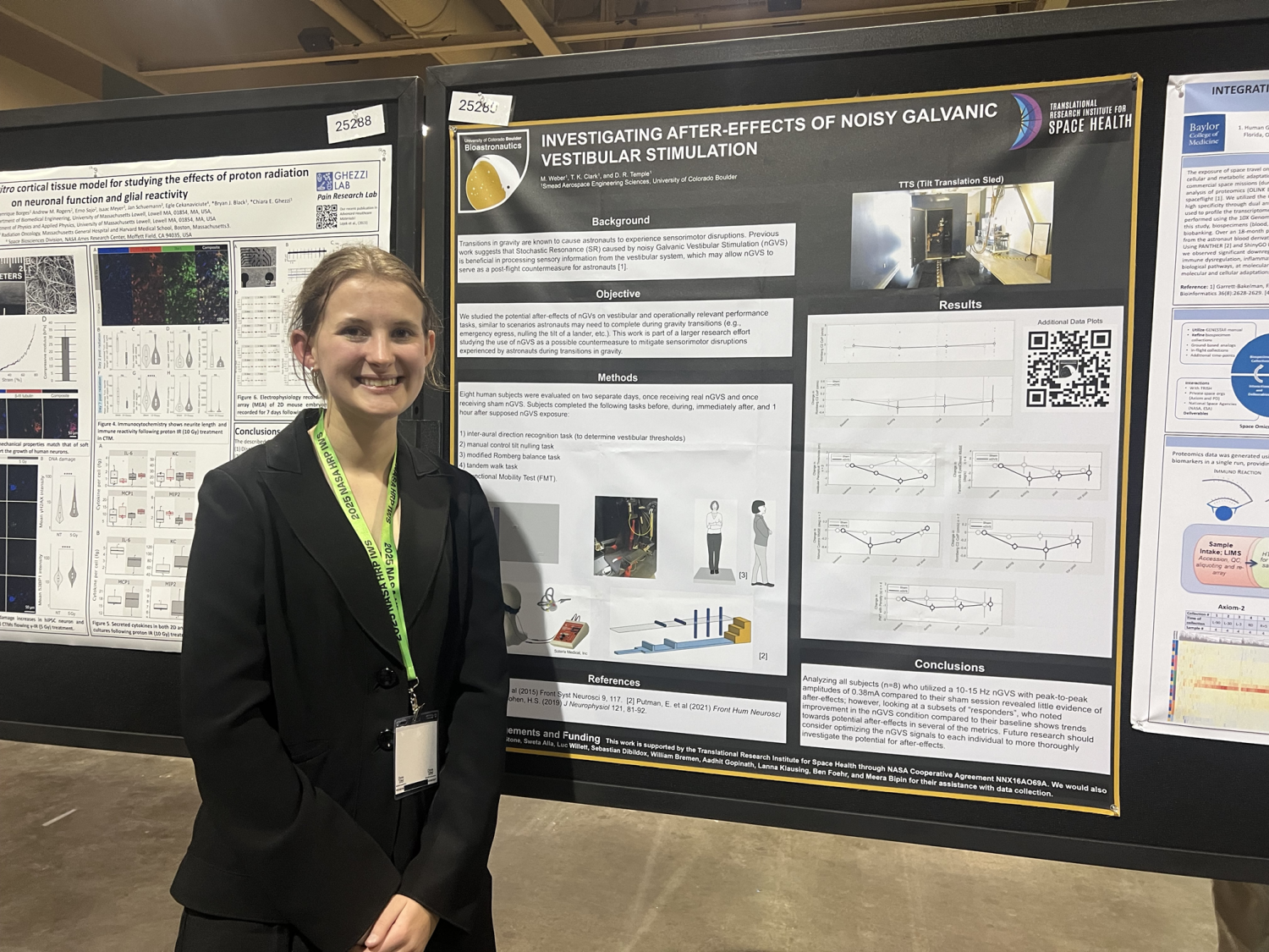 Student posing with their research poster
