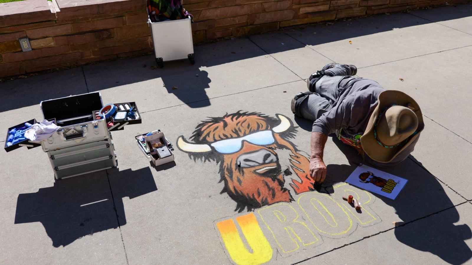 students creating chalk art