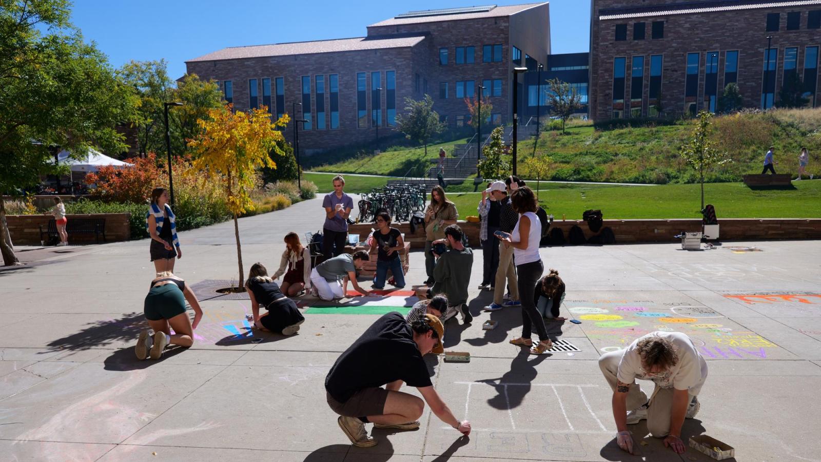 students creating chalk art