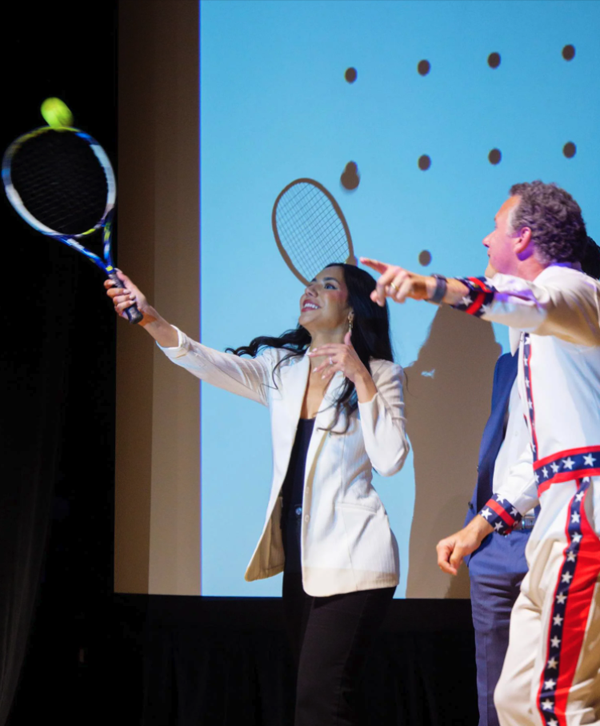 Brad Bernthal helps Vitro3D CEO and co-founder Camila Uzcategui hit a tennis ball into the crowd. Photo by Glenn Asakawa / CU Boulder.