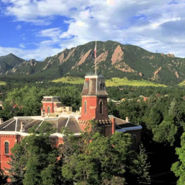Old Main building in front of the flatirons